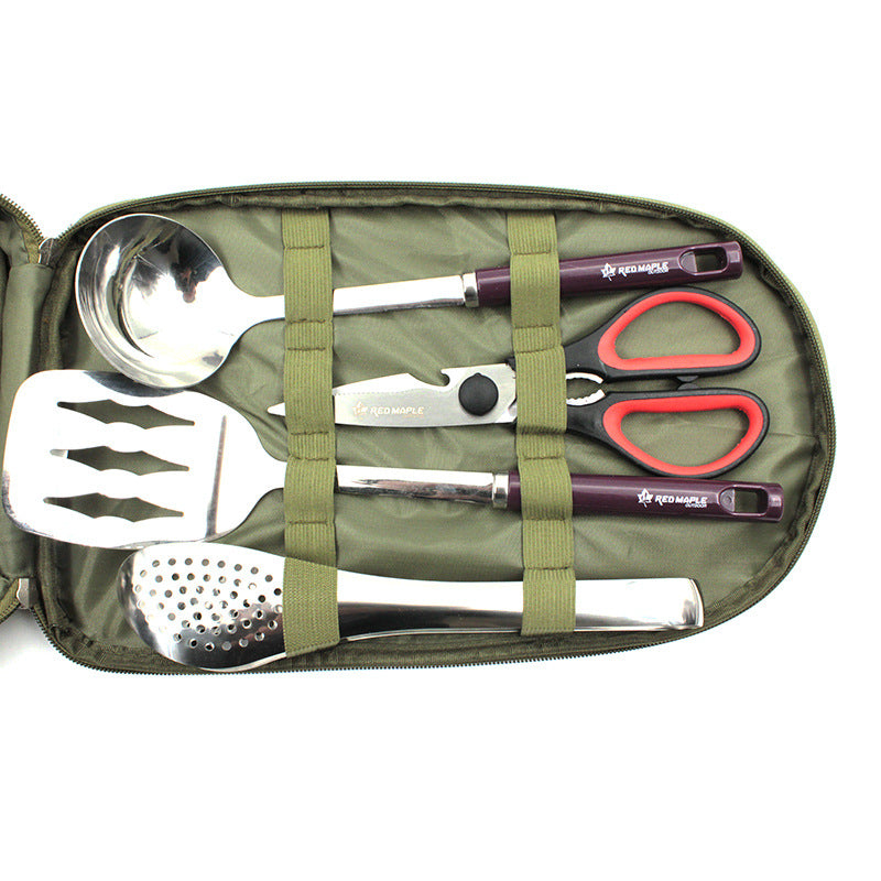Outdoor BBQ tool set close-up in olive green case with stainless tools and red handles