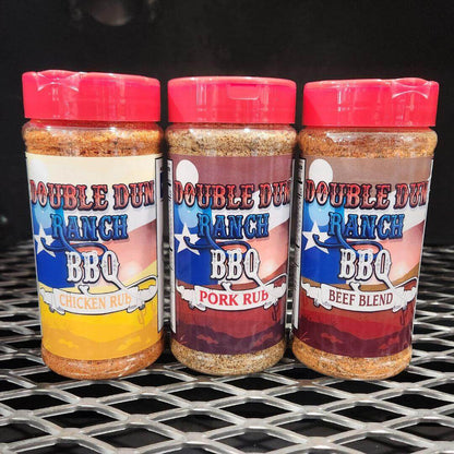 BBQ rub seasoning bottles with red caps on wire rack: chicken rub, pork rub, beef blend