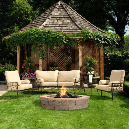 Round stone fire pit with flame, built-in dark metal fire bowl in yard