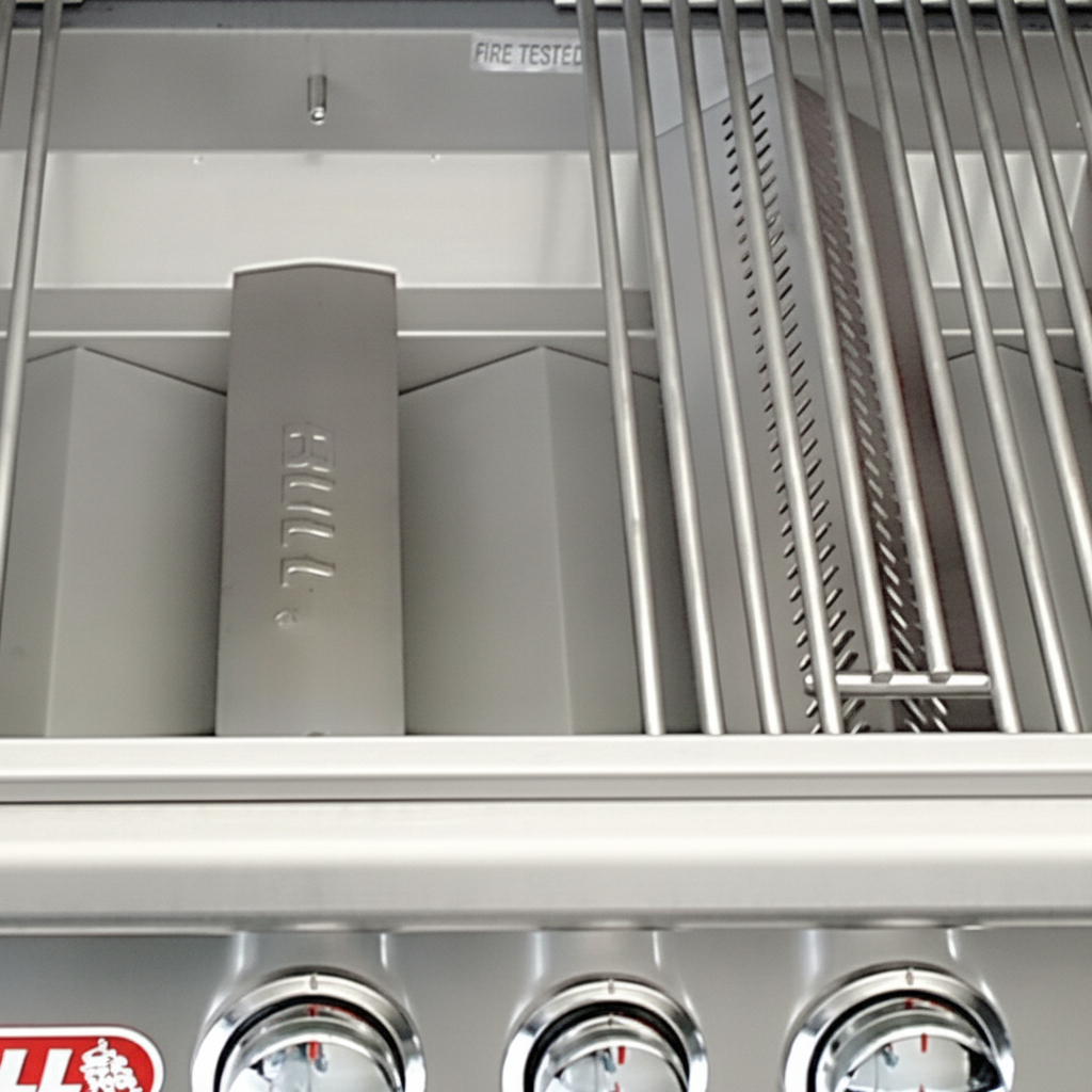Stainless steel grill interior with burner tubes and open cooking grate