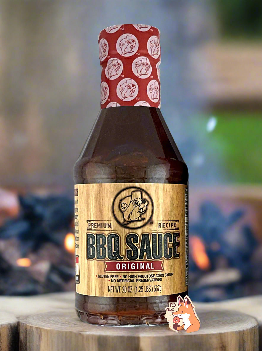 Original BBQ sauce bottle on wooden surface, red top and gold front label