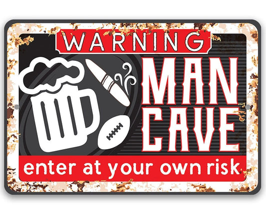 Metal warning sign with WARNING, MAN CAVE, and "enter at your own risk" text.