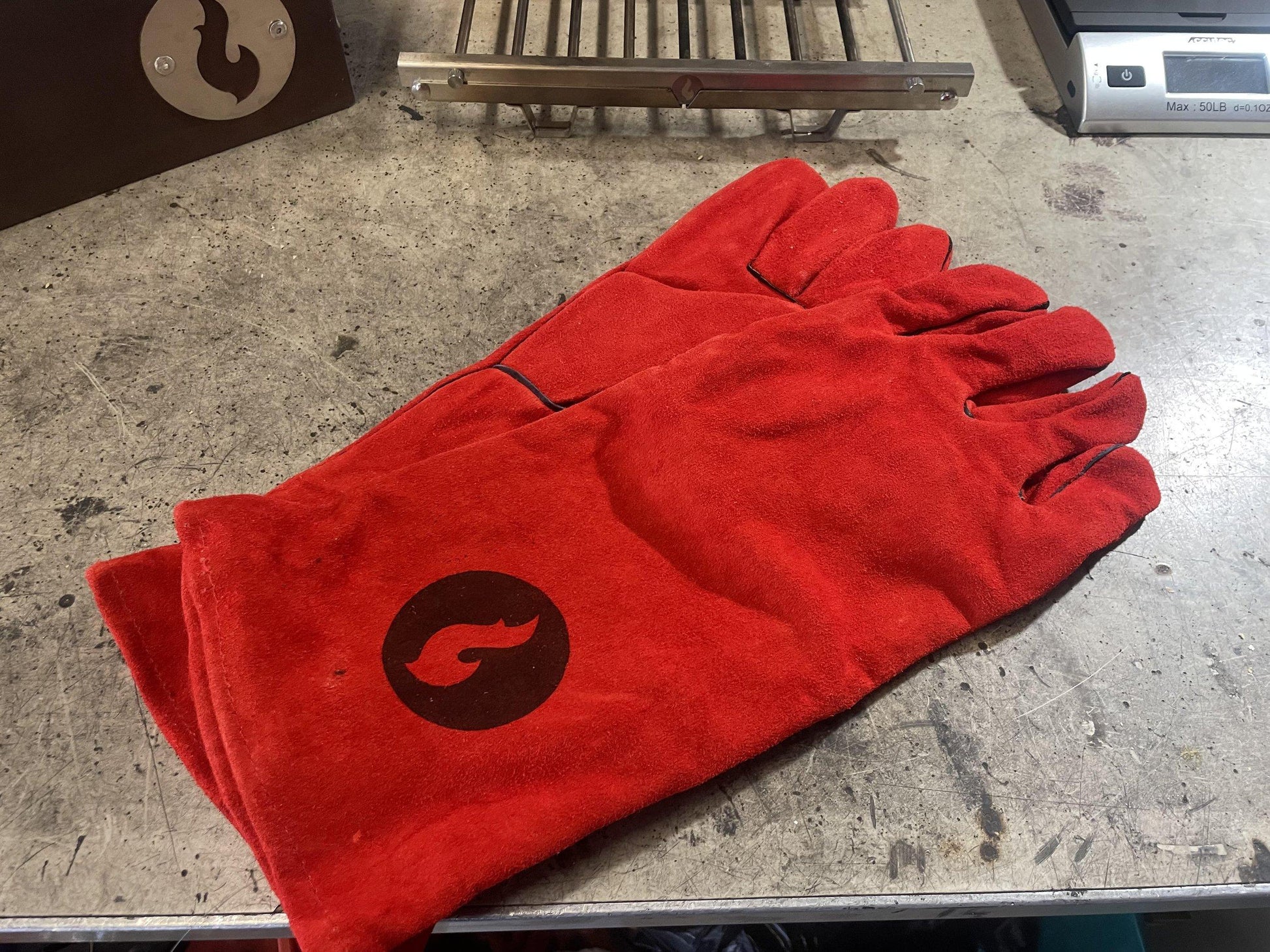 Red heat-resistant campfire gloves with flame logo, pair