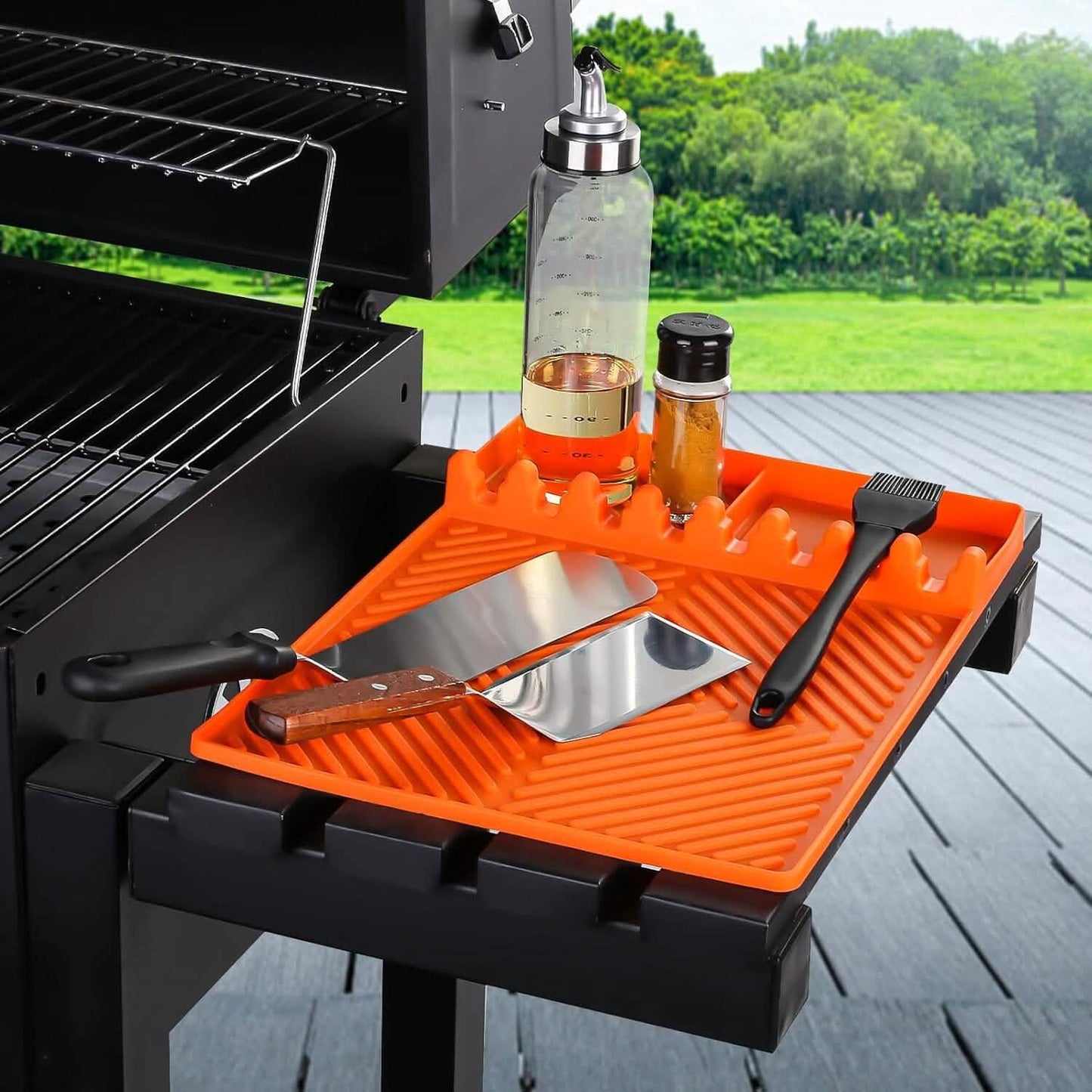 Orange silicone side shelf mat with ridged grooves and utensil slots on a griddle