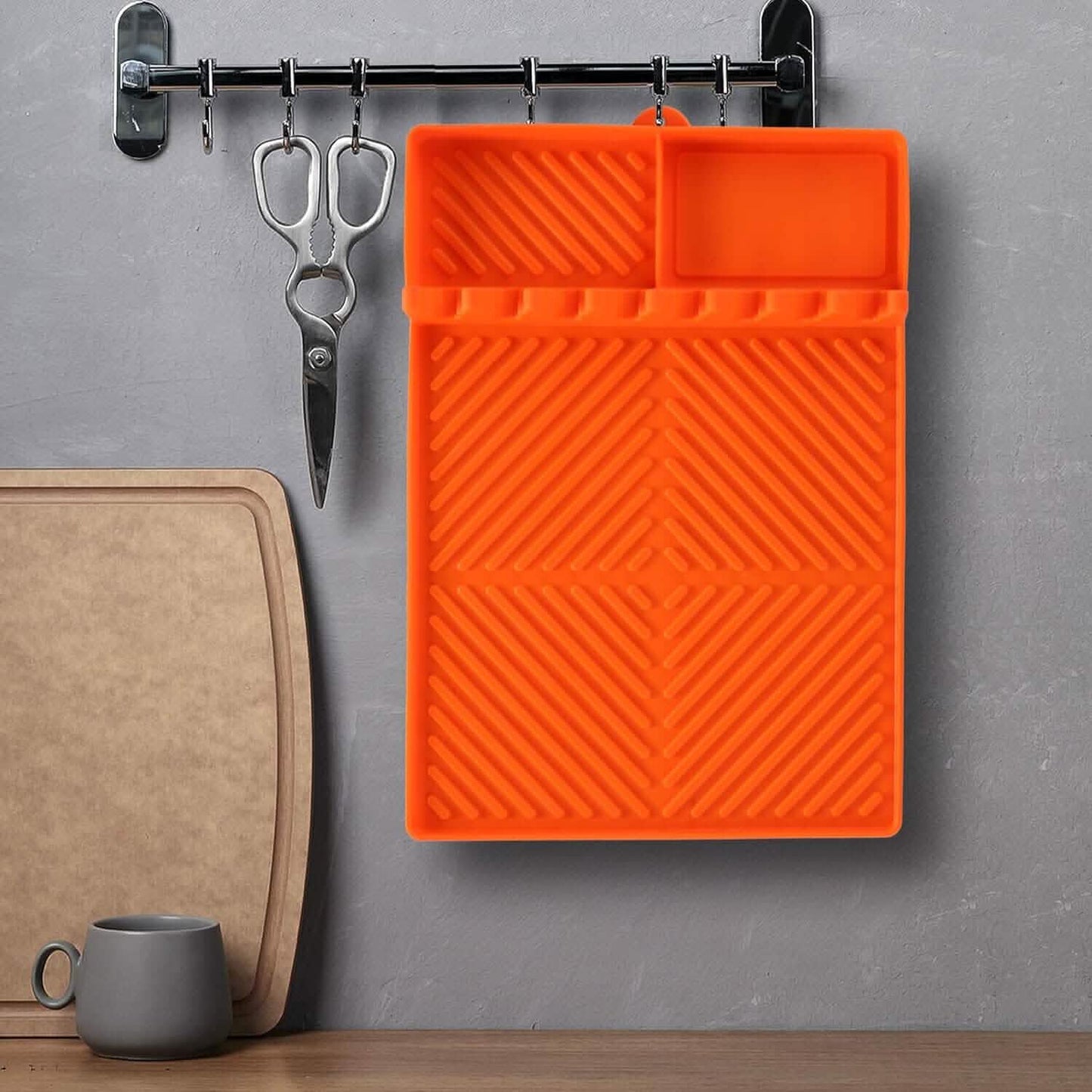 Orange silicone grill side mat with ridged texture and two raised sections