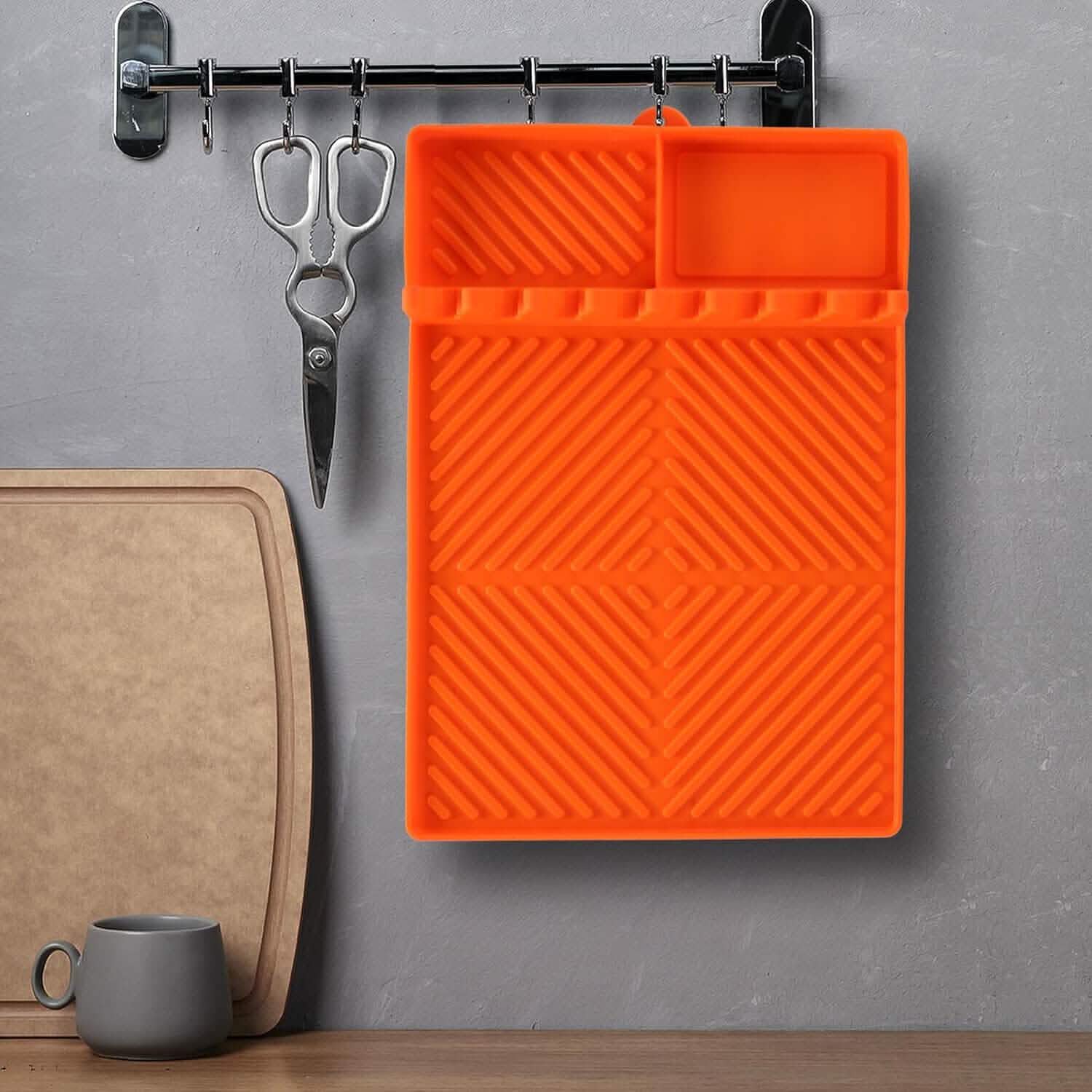 Orange silicone grill side mat with ridged texture and two raised sections