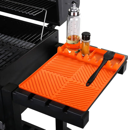 Orange silicone grill side shelf mat with raised ridges and utensil holder grooves