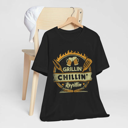 Black graphic BBQ T-shirt with grill and chillin’ refillin’ emblem on hanger