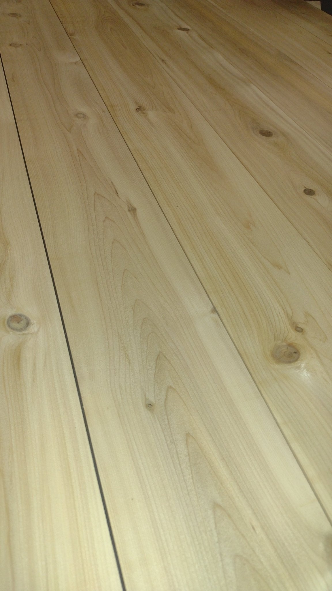 Light cedar tabletop surface with visible wood grain and plank seams