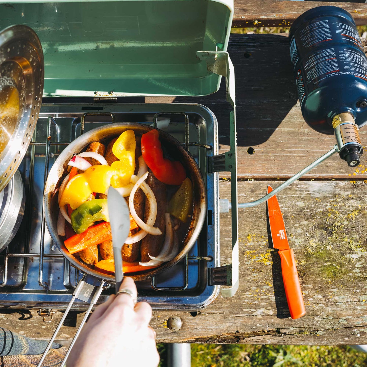 TapRack refillable propane cylinder connected to gas grill via hose
