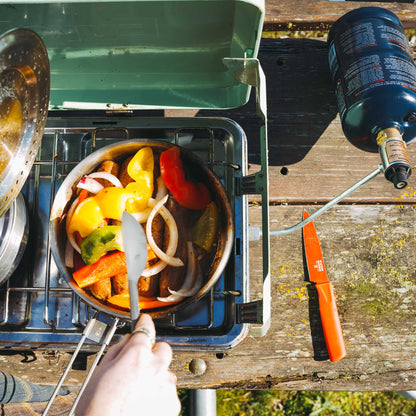 TapRack refillable propane cylinder connected to gas grill via hose