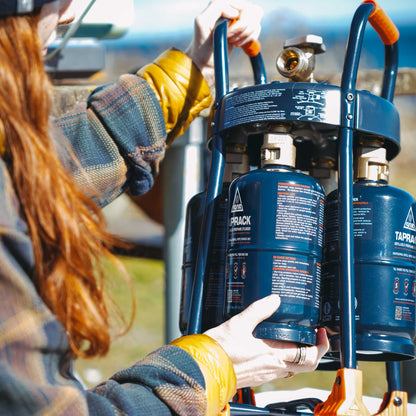 TapRack refillable propane cylinder with regulator connection and blue frame