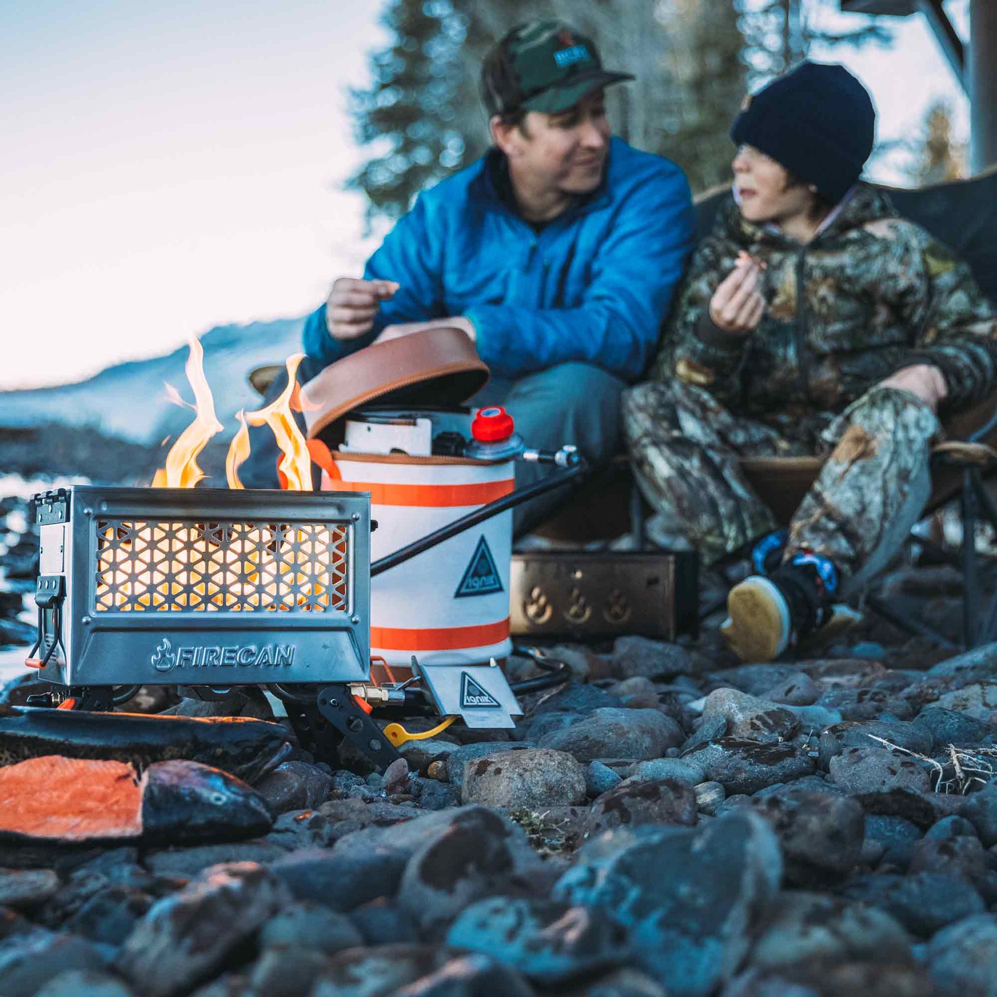FireCan Deluxe portable fire pit on coals with flames through the vent and control knob