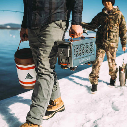 FireCan Deluxe portable fire pit being carried with connected gas hose and canister