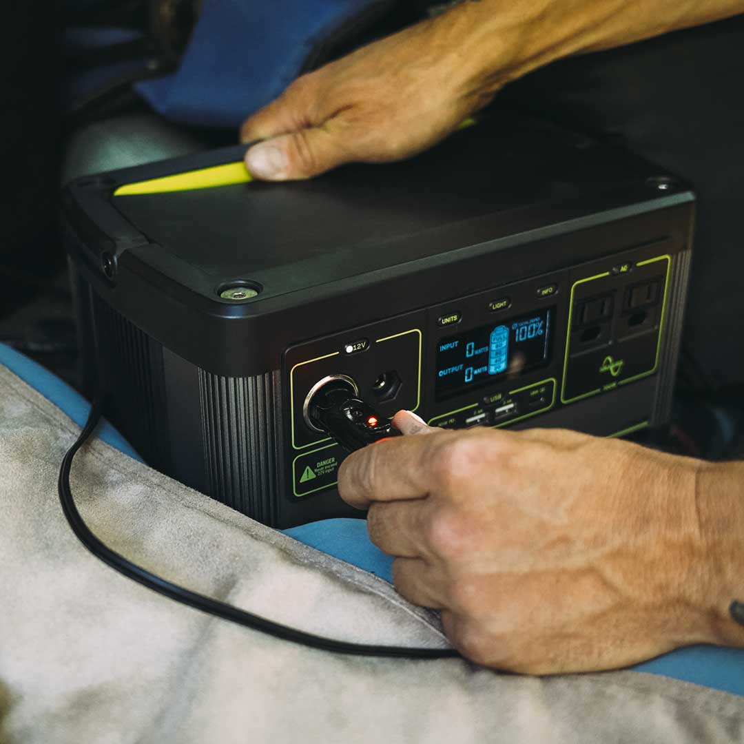 Portable power station with connected cable, powering a heated bed cover blanket