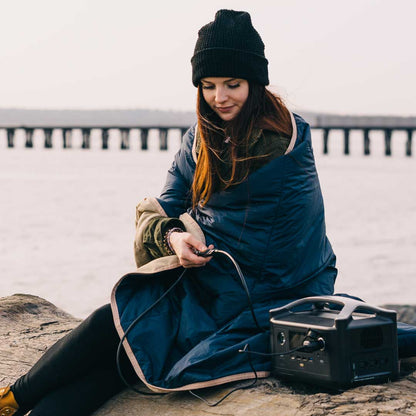 Blue heated blanket on rocky shore with power station connected to the controller