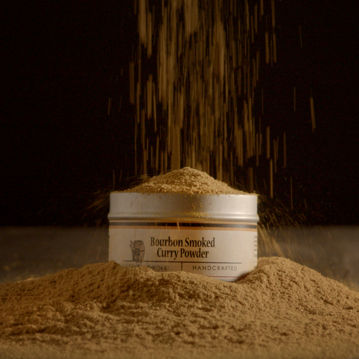 Bourbon smoked curry powder jar with gold-brown powder mound and label