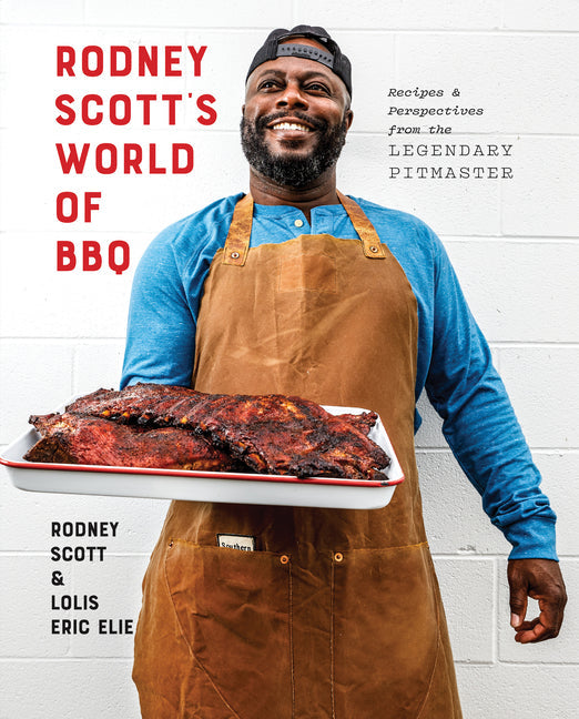 BBQ cookbook cover with large red title text and chef in blue shirt holding tray