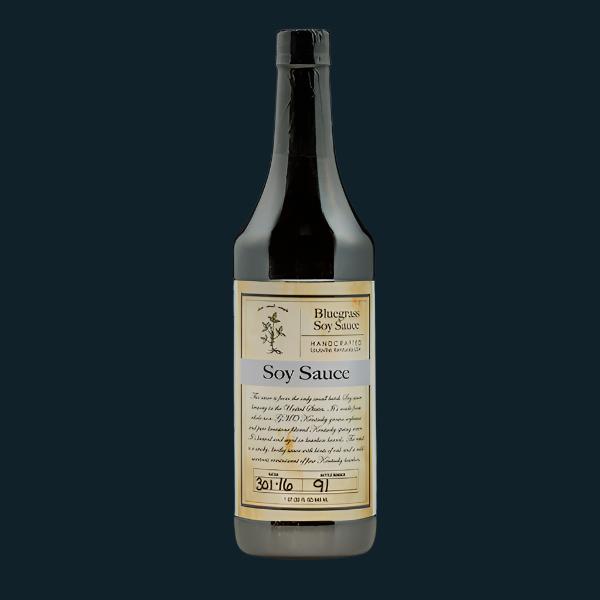 Soy sauce bottle, dark brown liquid, cream label, metal cap