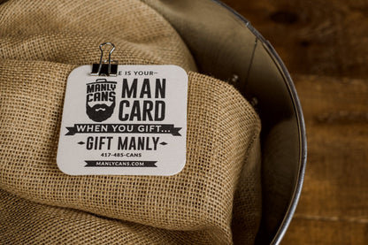 Man Card gift tag with text “MAN CARD” and “When you gift… gift manly” clipped on burlap.