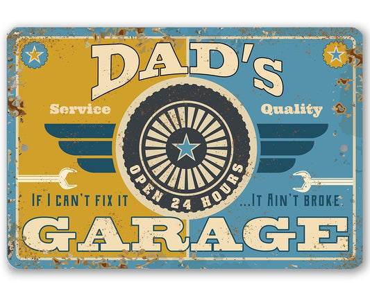 Blue and gold Dad's Garage metal sign with gear-wheel emblem and wings, rounded corners
