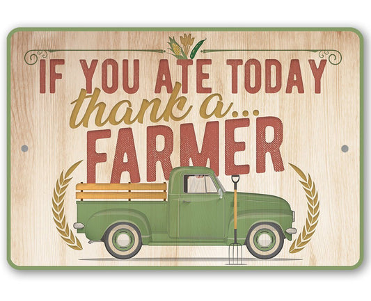 Metal farm sign with green truck and “If you ate today, thank a farmer” text
