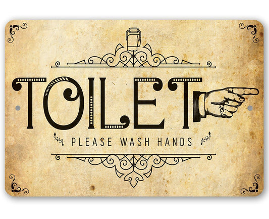 Metal toilet directional sign with 'TOILET' text and right-pointing hand icon