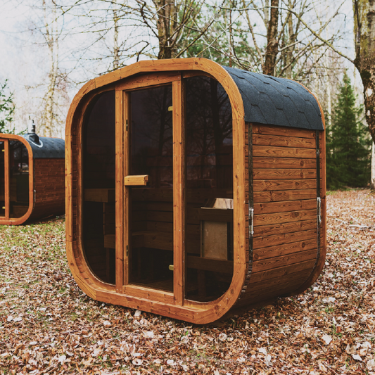 ThermoWood sauna cabin with arched glass door and dark shingle roof, outdoor ready