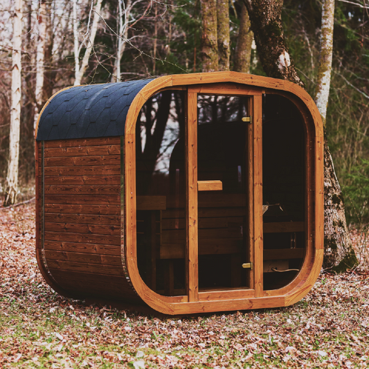 Wooden outdoor sauna barrel with glass door and dark roof, front view
