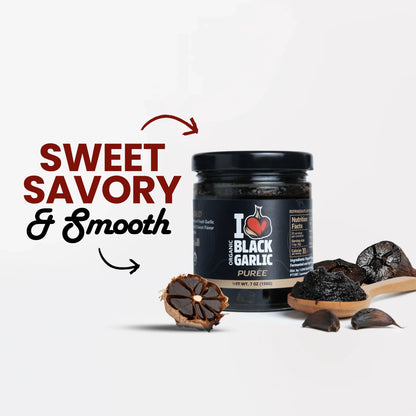 Black garlic purée jar with logo, surrounded by black garlic cloves and bread slices