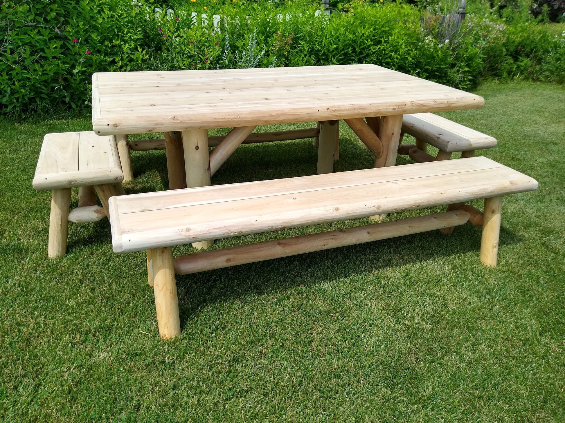Cedar log picnic table with two benches, light wood, front-angle view