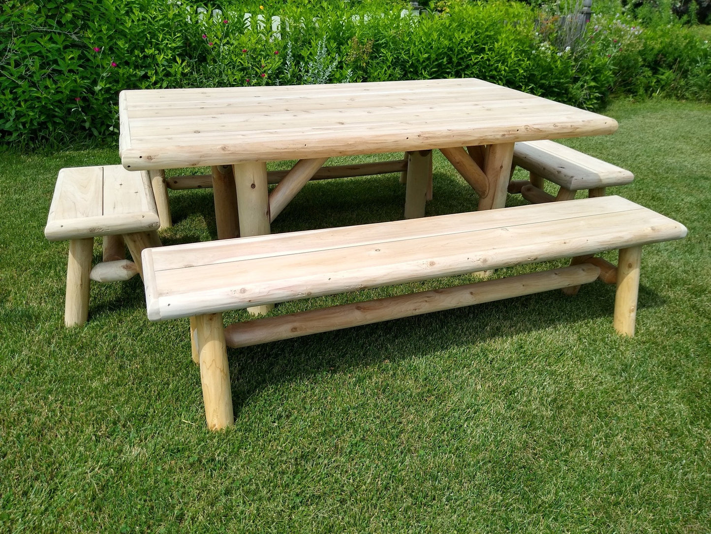 Cedar log picnic table with matching benches, light wood, side view