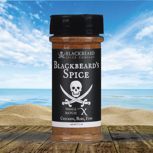 Blackbeard's Spice jar with black cap, filled with brown spice blend.