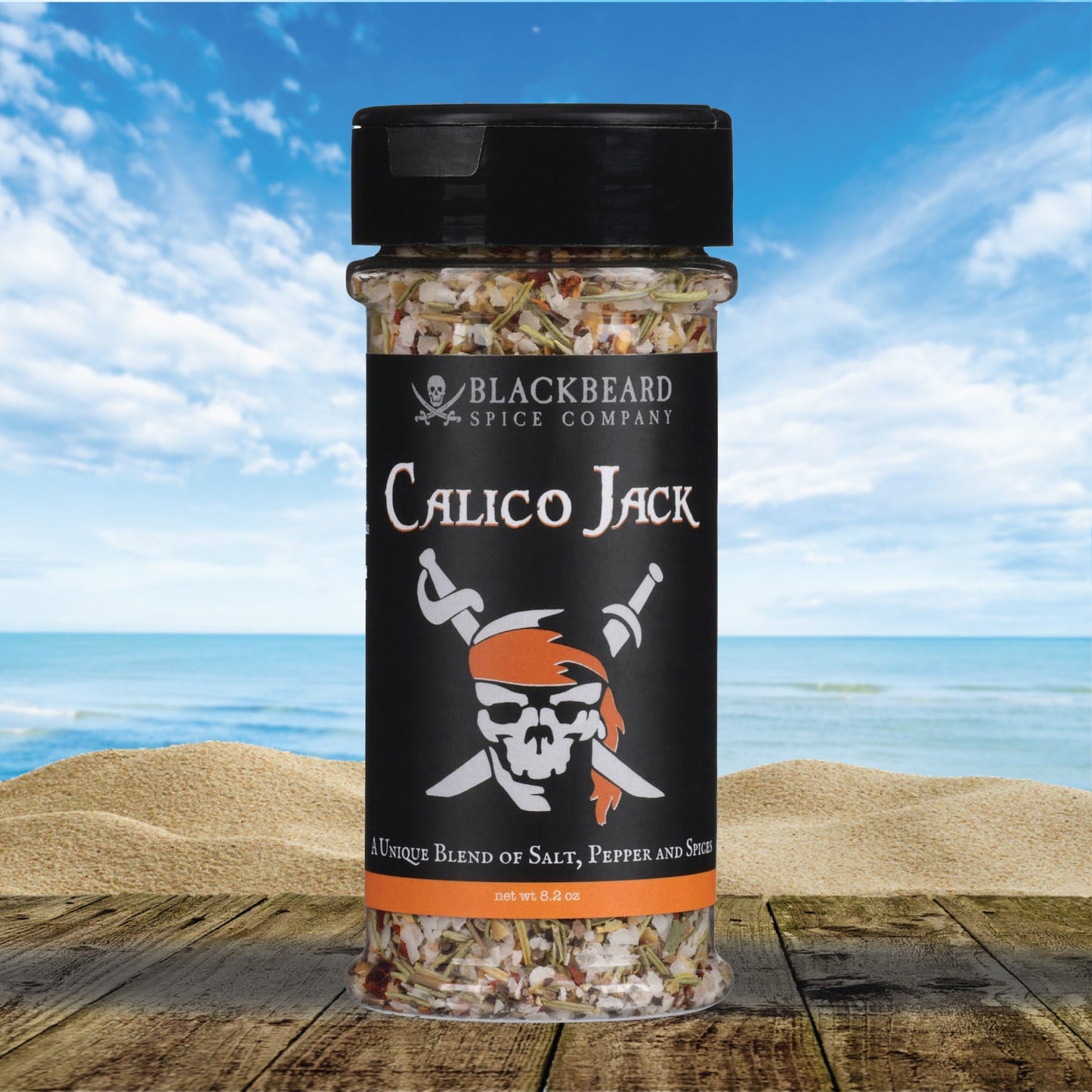 Calico Jack seasoning bottle, clear glass with black cap, Blackbeard Spice Co. label