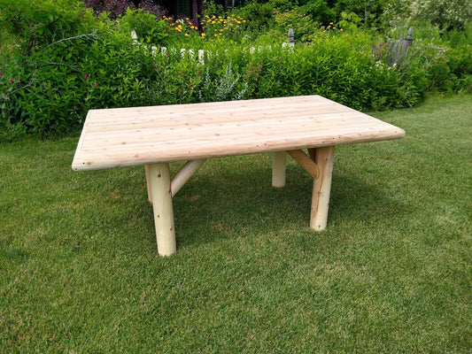Outdoor wooden patio table with rectangular slatted top and four tapered legs
