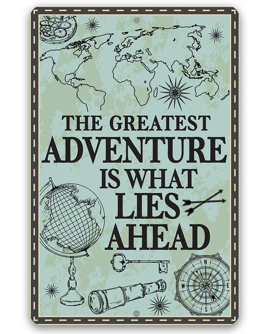 Metal sign with globe, compass, and quote “The Greatest Adventure Is What Lies Ahead”