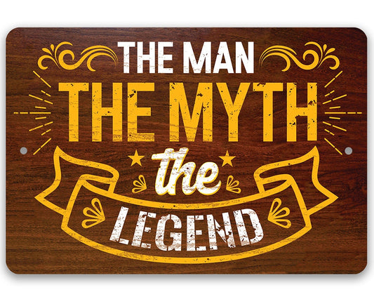 Metal sign with gold lettering: “The Man” “The Myth” “The Legend”