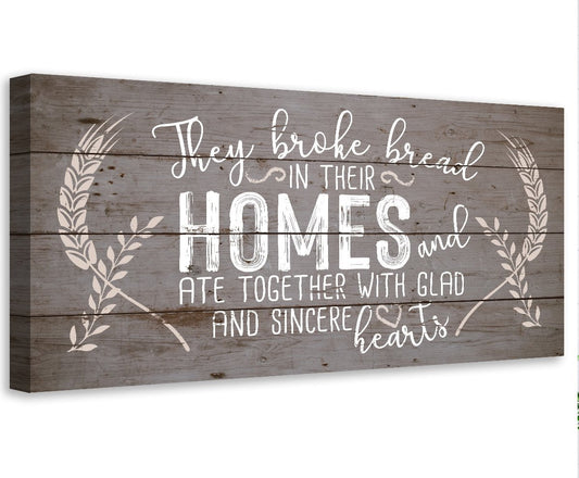 Brown canvas wall art with white script 'Homes' and laurel branches.