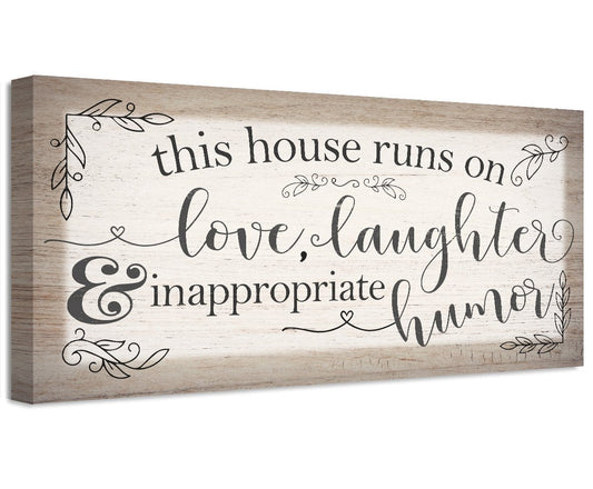 Stretched canvas with script quote: 'this house runs on love, laughter & inappropriate humor'