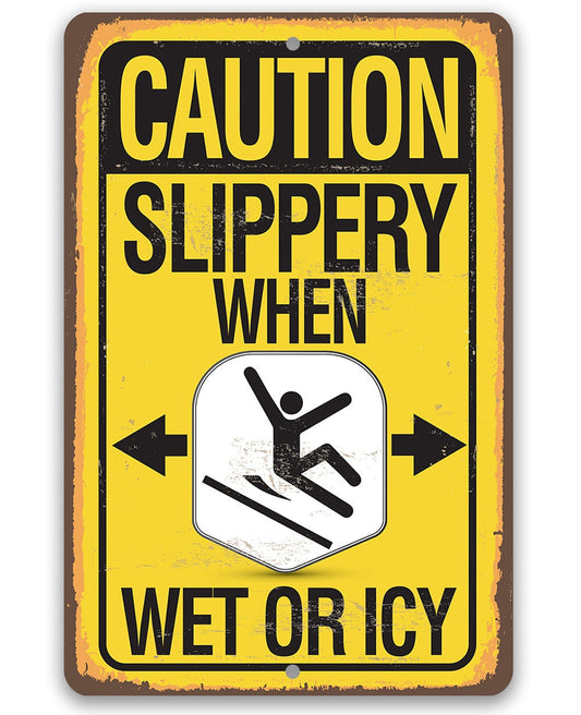 Caution slippery wet or icy metal sign with yellow background and slip icon