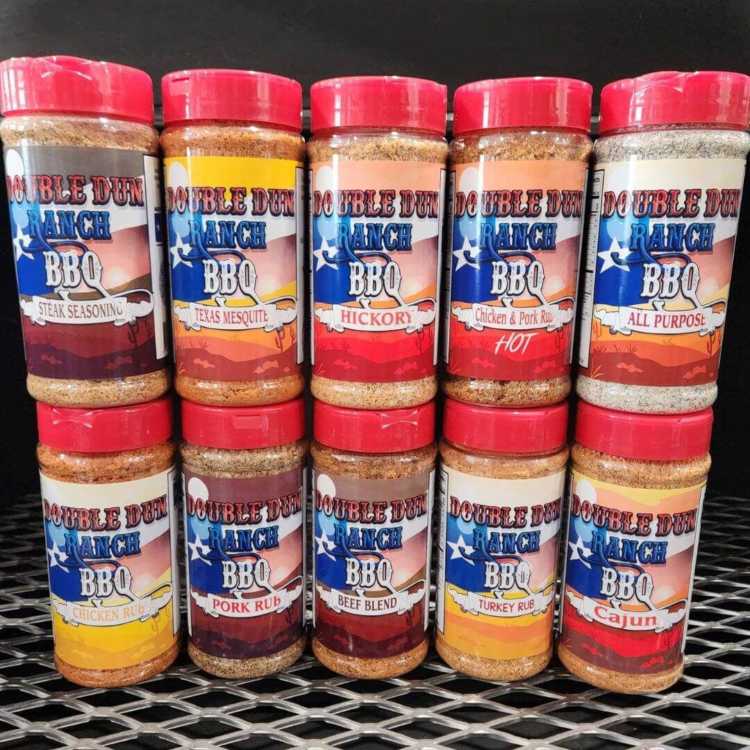 BBQ rub variety set close-up of red-lidded seasoning bottles with spice-speckled tops